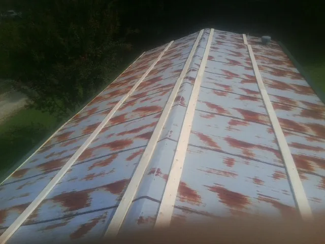 Rusted metal roof panels with new wood purlins before replacement — Storm Damage Roof Repair in Bellwood by Roofing Brothers